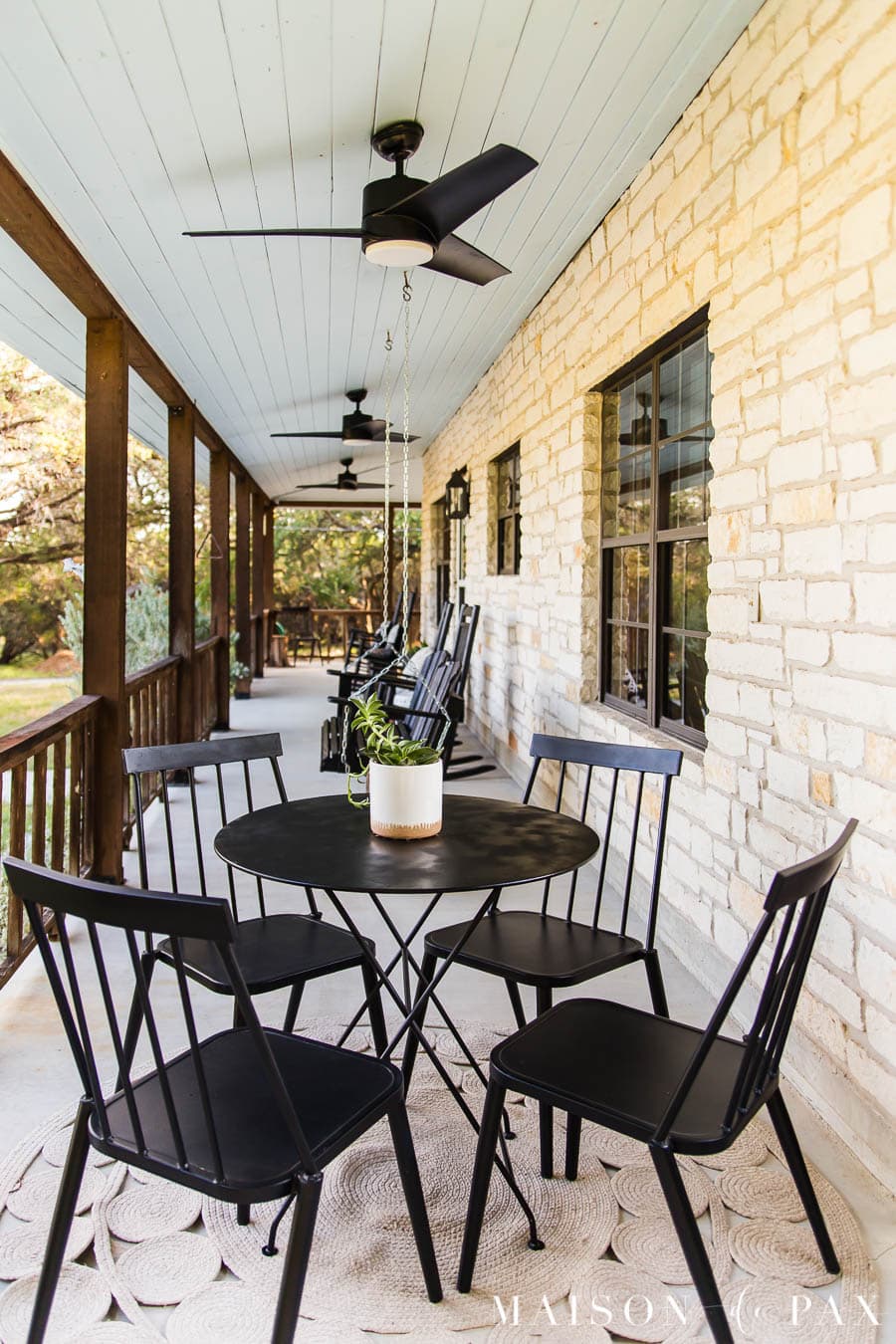 austin stone front porch with haint blue ceiling and black outdoor fans | Maison de Pax