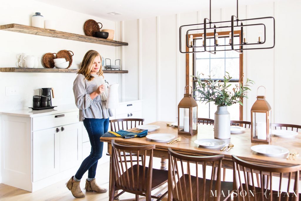 woman bringing white pitcher to casual elegant dining table | Maison de Pax