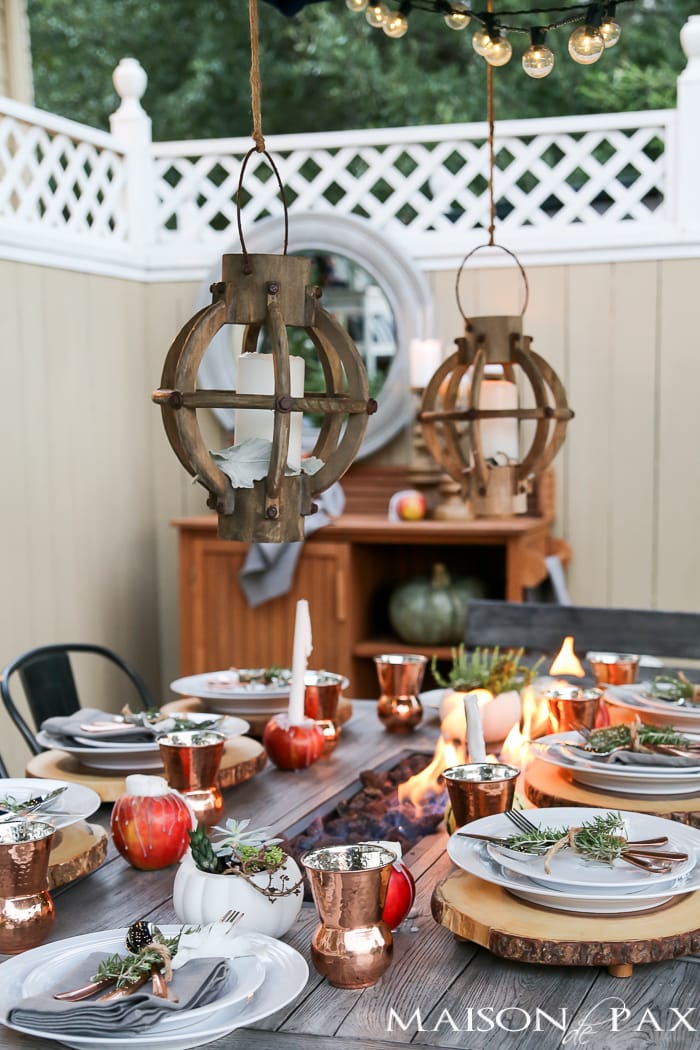 Create a rustic outdoor wedding table with unique candles, string lights, and greenery - Maison de Pax