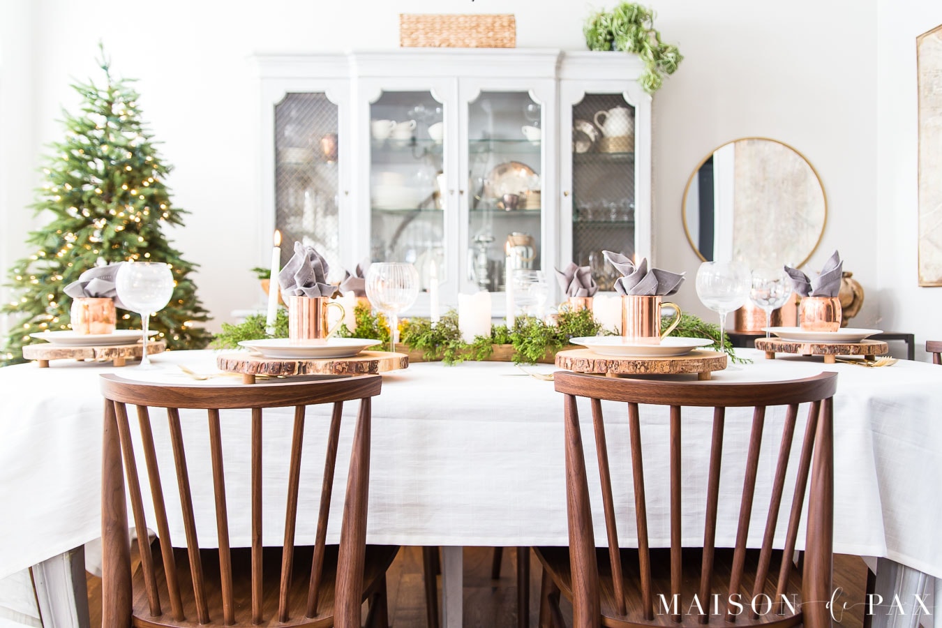 brown wood rung modern farmhouse chairs at a dining table with a white tablecoth