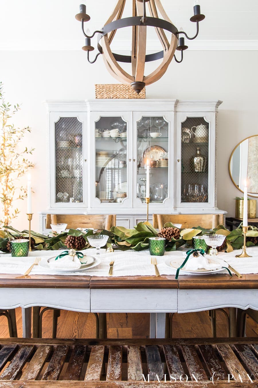 table decorated for Christmas dinner with bells and green ribbon | Maison de Pax
