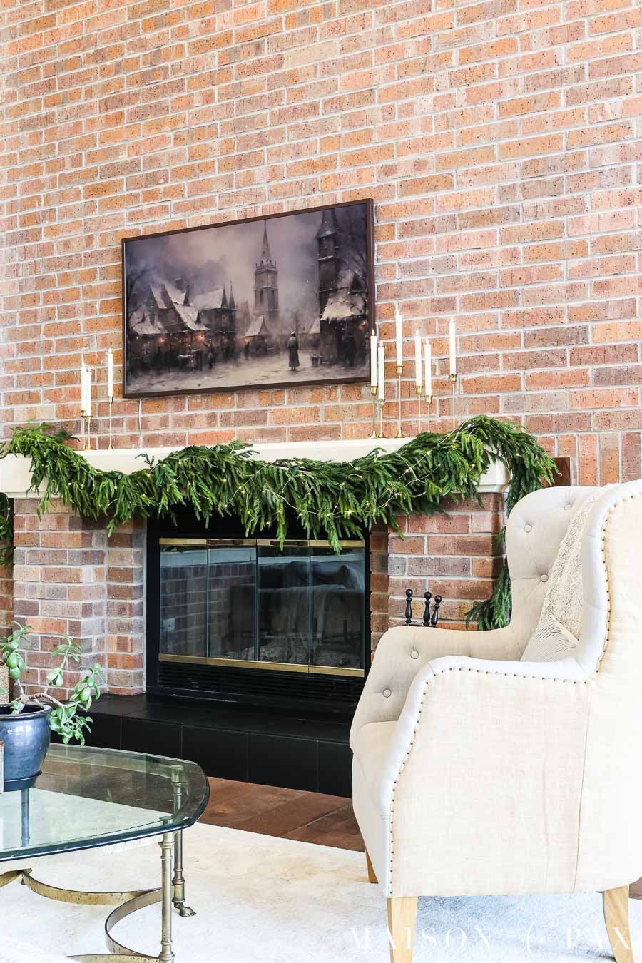 full wall brick mantel with christmas decorations garland greenery and twinkle lights