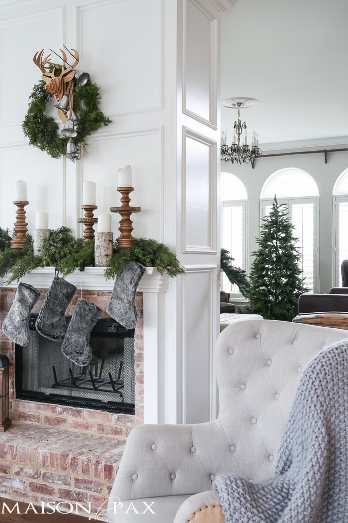 Winter Woodland Christmas Mantel: Looking for mantel decorating ideas? Some fresh cut cedar, candlesticks, and a faux deer mount creates the perfect holiday decor.