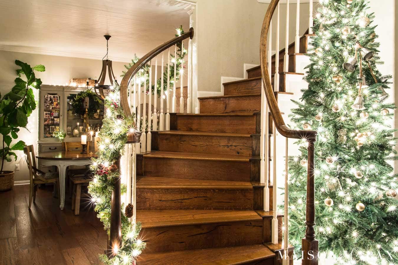 large christmas tree in curved stairwell | Maison de Pax