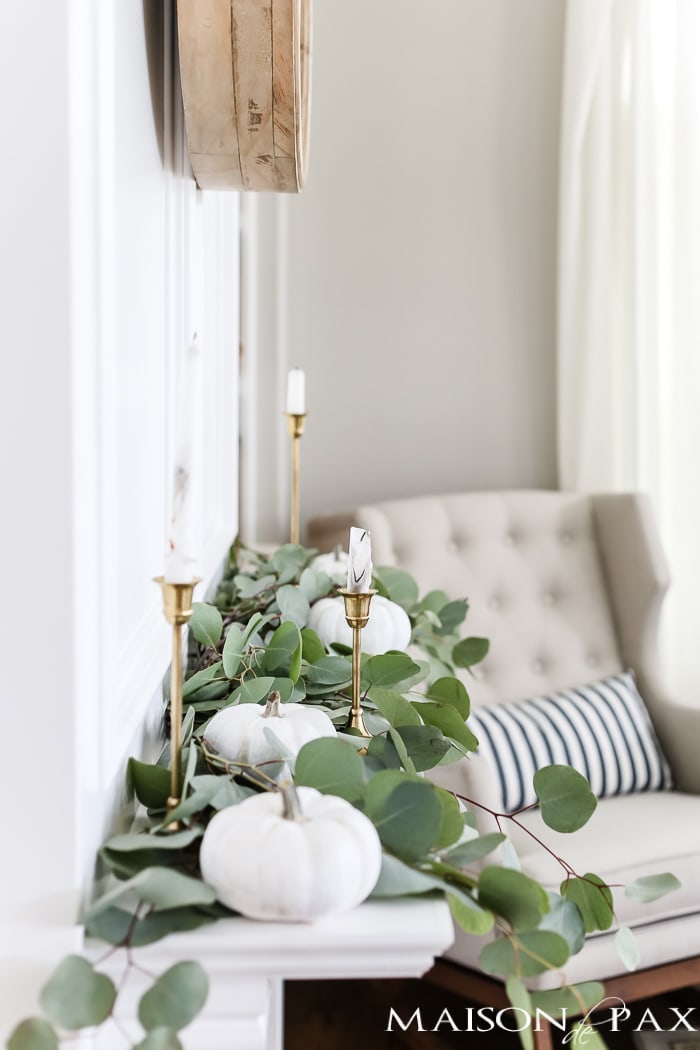 silver dollar eucalyptus and white pumpkins and brass candlesticks make elegant neutral fall decor