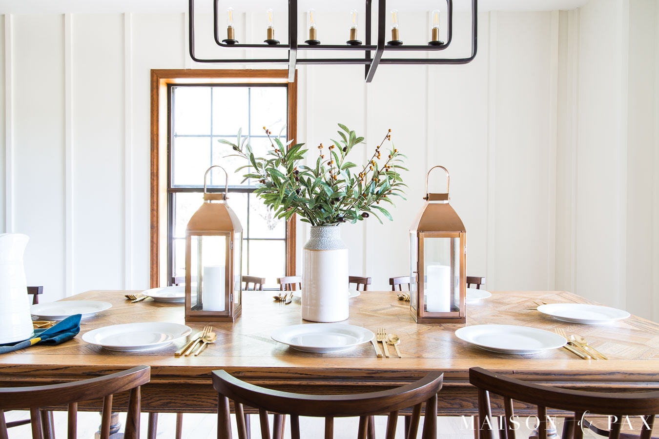 olive branches and berries centerpiece with copper lanterns | Maison de Pax