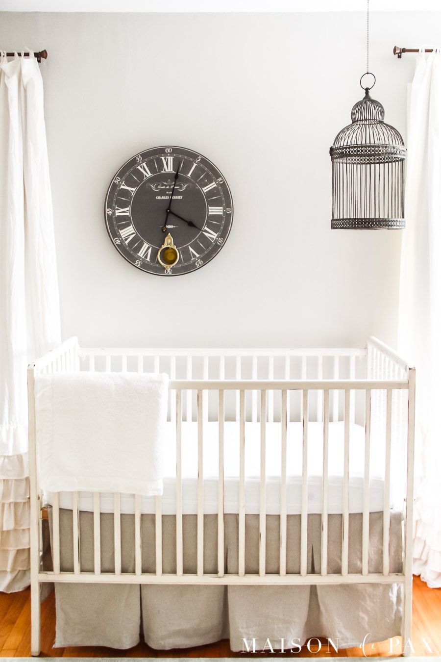 Nursery with antique white crib and curtains and SW Agreeable Gray walls | Maison de Pax