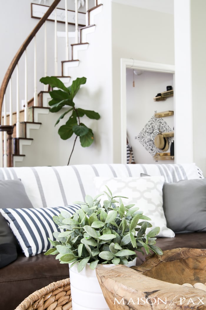 How to turn closet into mudroom: What an adorable space! Baskets and hooks turn a closet under the stairs into a functional mudroom space for a family.