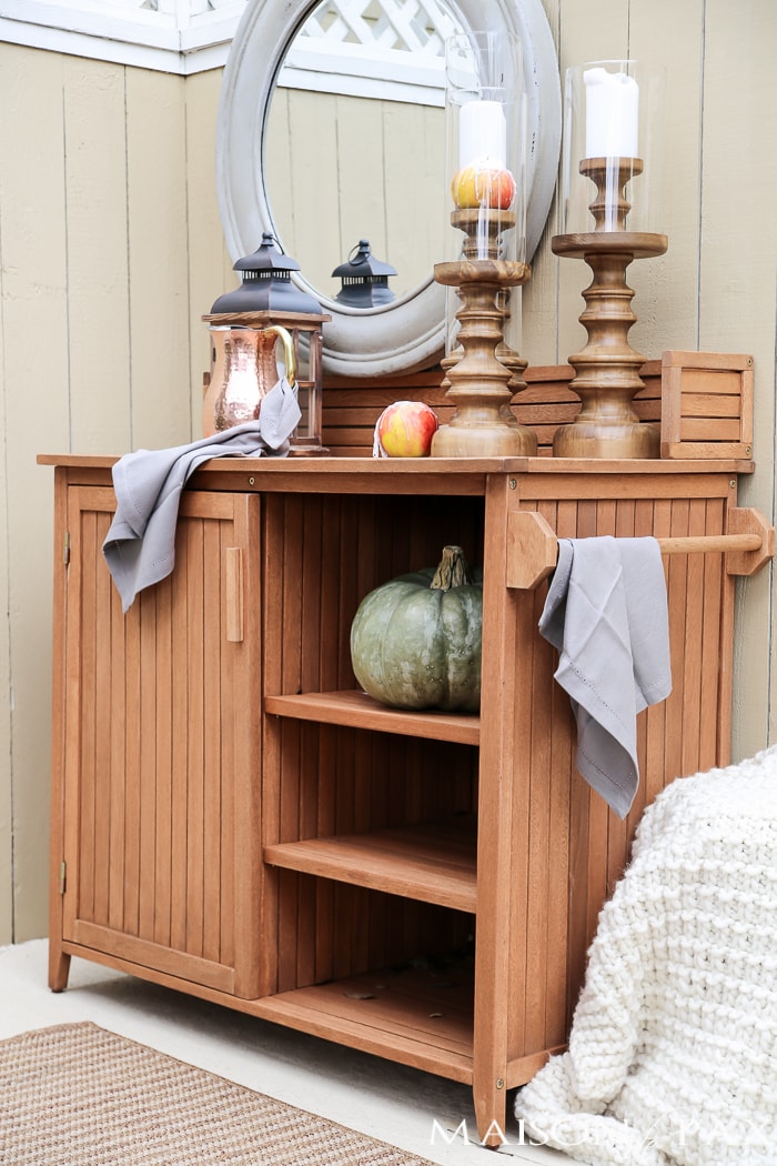 outdoor fall tablescape: lanterns, string lights, apple candles, and other cozy outdoor fall decorating ideas!