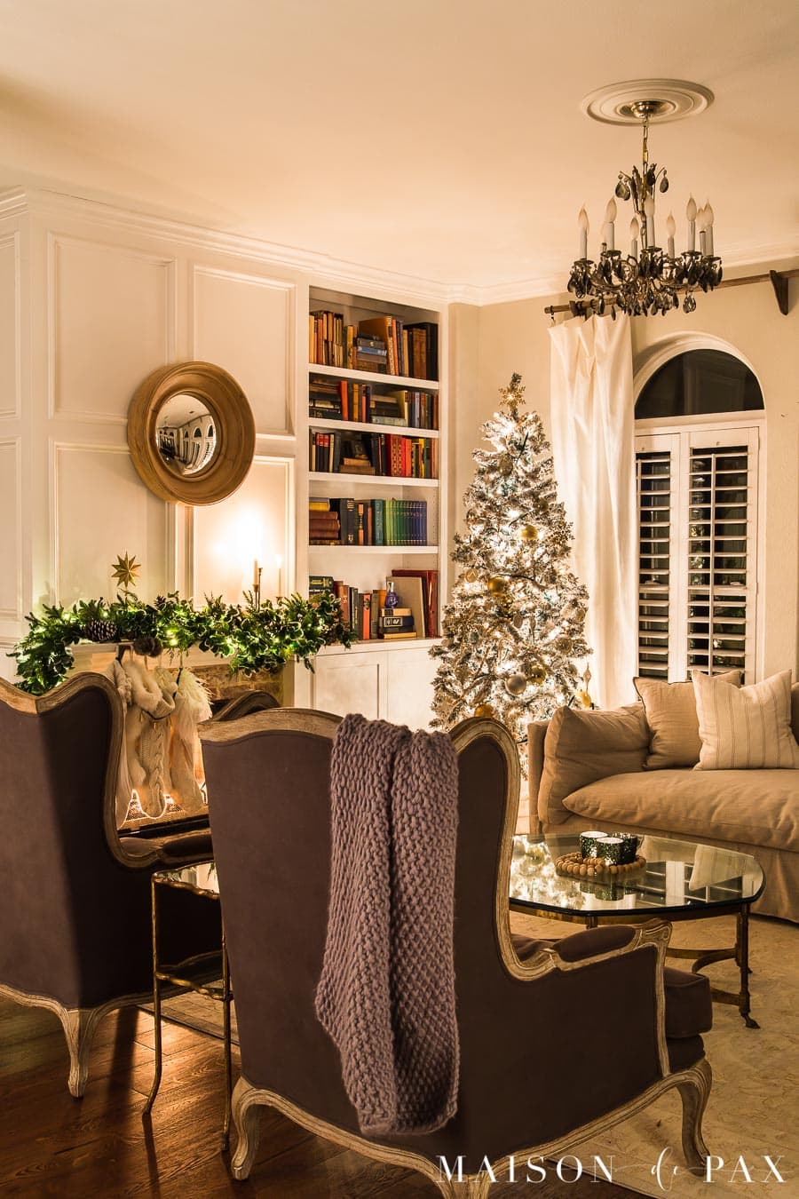 Living room lit up at night by Christmas tree and string lights | Maison de Pax