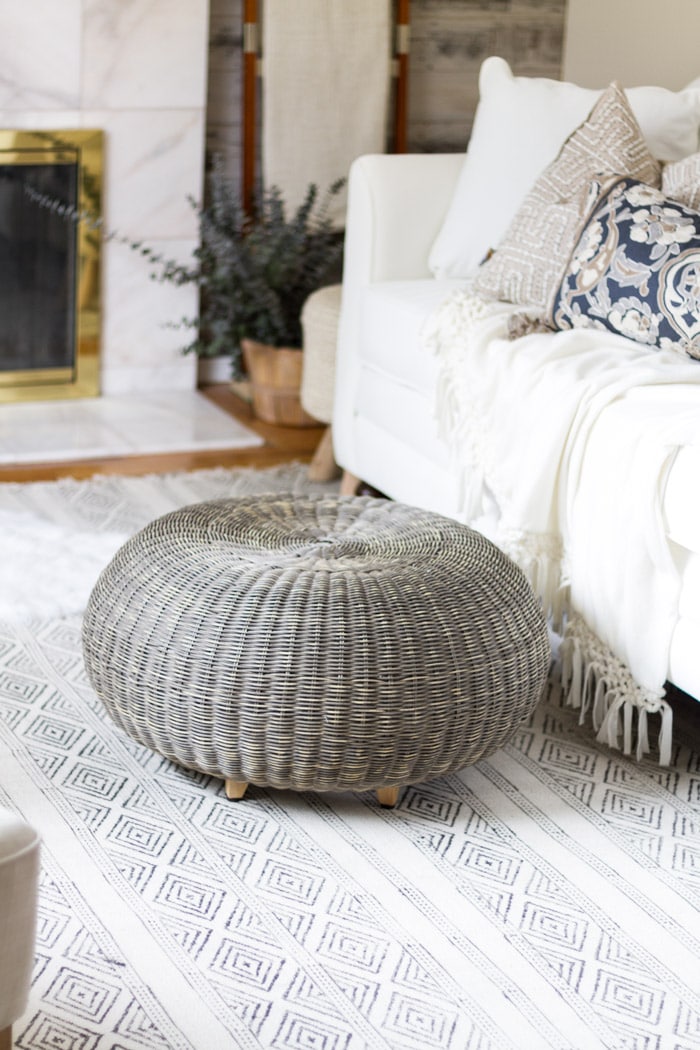 Gray pouf and light blue area rug-  Maison de Pax