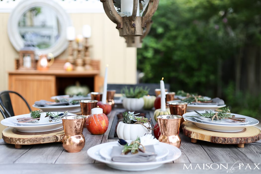 10 tips for a magical outdoor dining table: lanterns, string lights, apple candles, and other cozy outdoor fall decorating ideas!