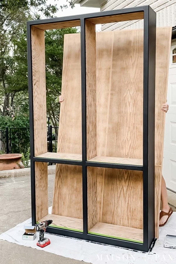assembling black and light wood bookcase