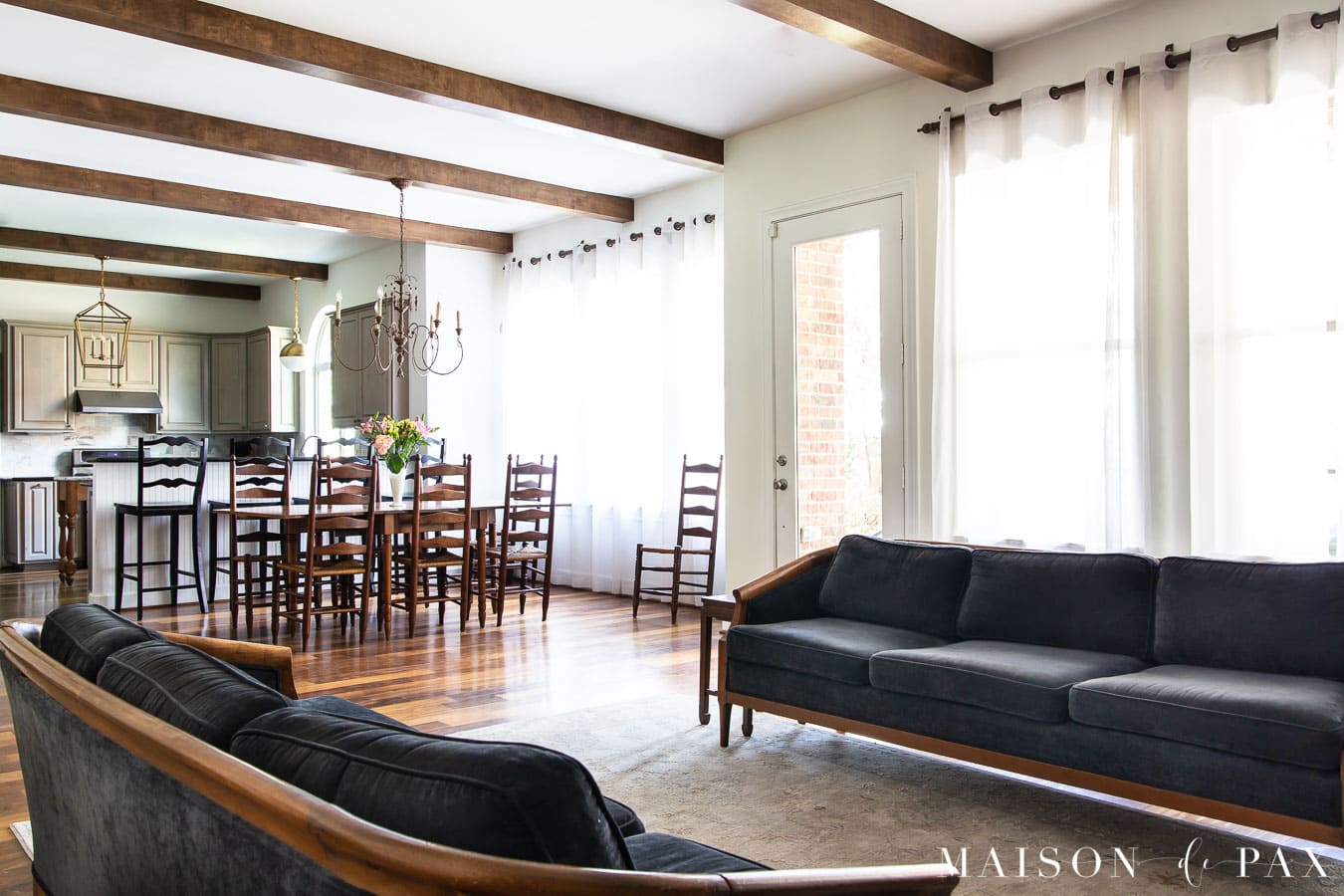 open living and dining with SW Alabaster walls and dark wood floors