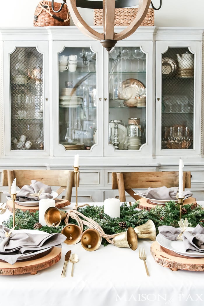 wood slice chargers, mini green wreaths and brass candlesticks, classic green and gold holiday tablescape- Maison de Pax