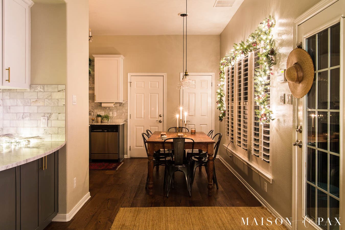 kitchen table and bar with twinkly lights and garland | Maison de Pax
