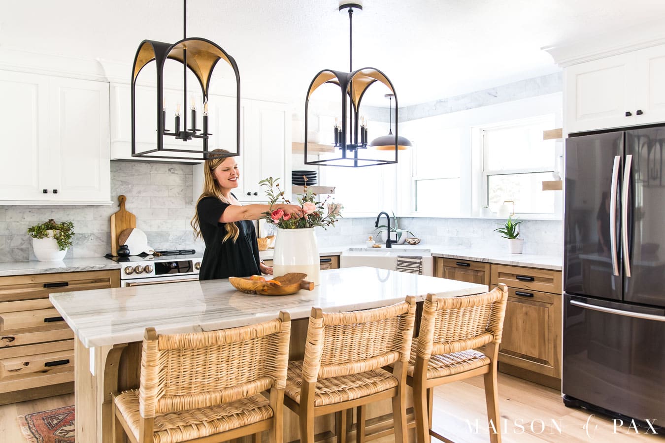 woman arranging flowers on kitchen island