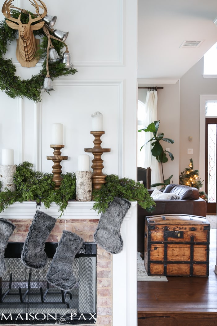 Winter Woodland Christmas Mantel: Looking for mantel decorating ideas? Some fresh cut cedar, candlesticks, and a faux deer mount creates the perfect holiday decor.