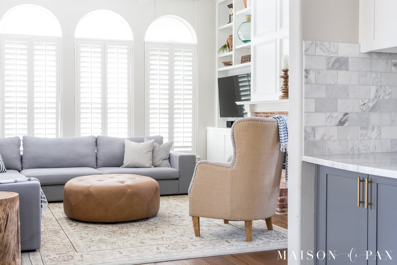 5 tips for creating a light, bright living space: built-in bookcases around the fireplace and a large sectional make this space so beautiful and functional!
