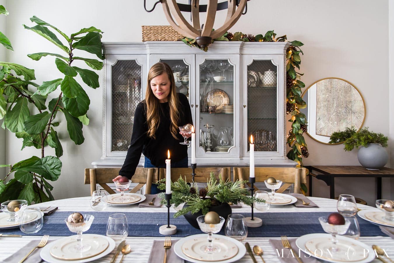 woman decorating Christmas dining table