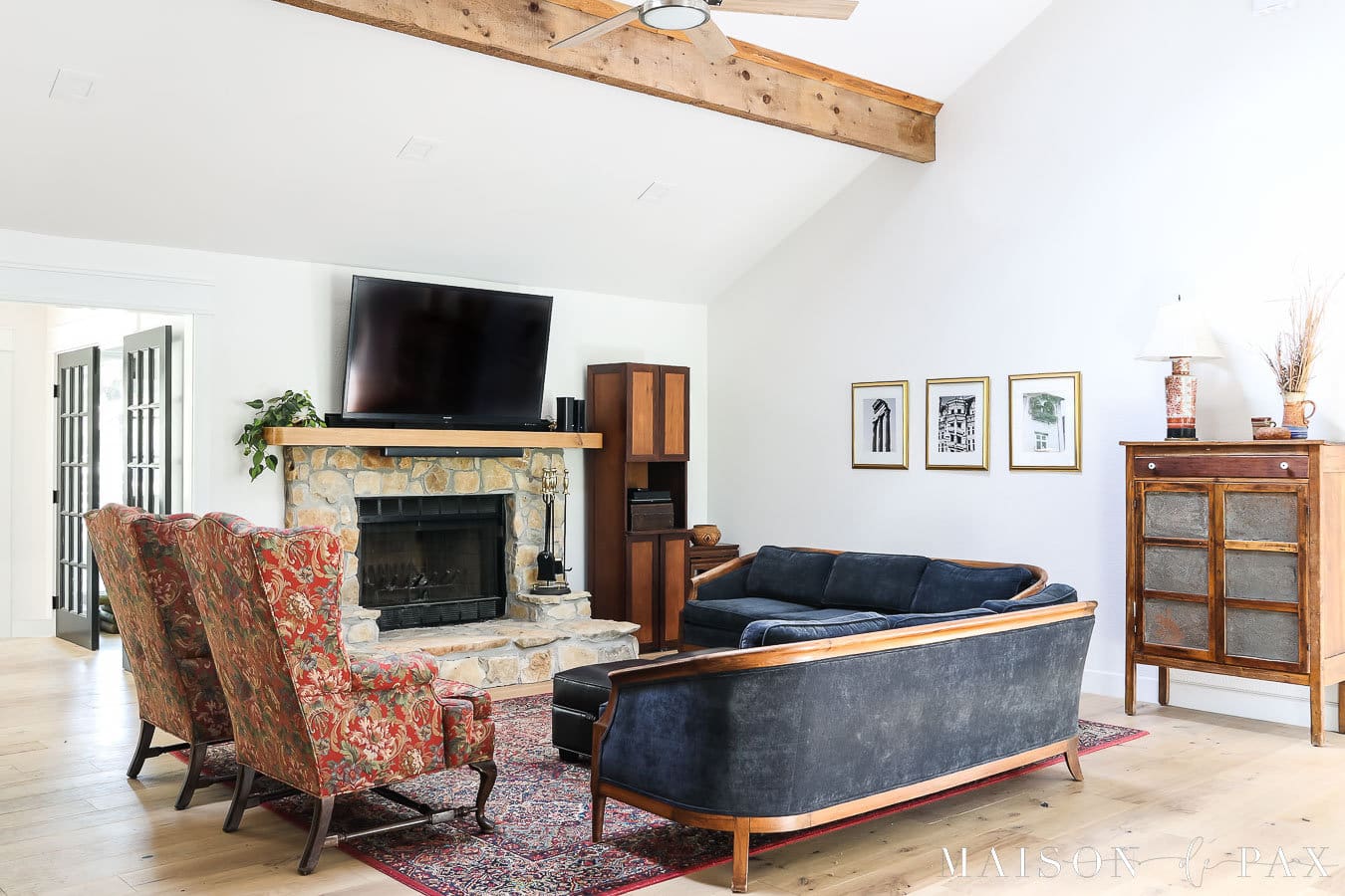 living room with fireplace, vaulted ceiling, and beams