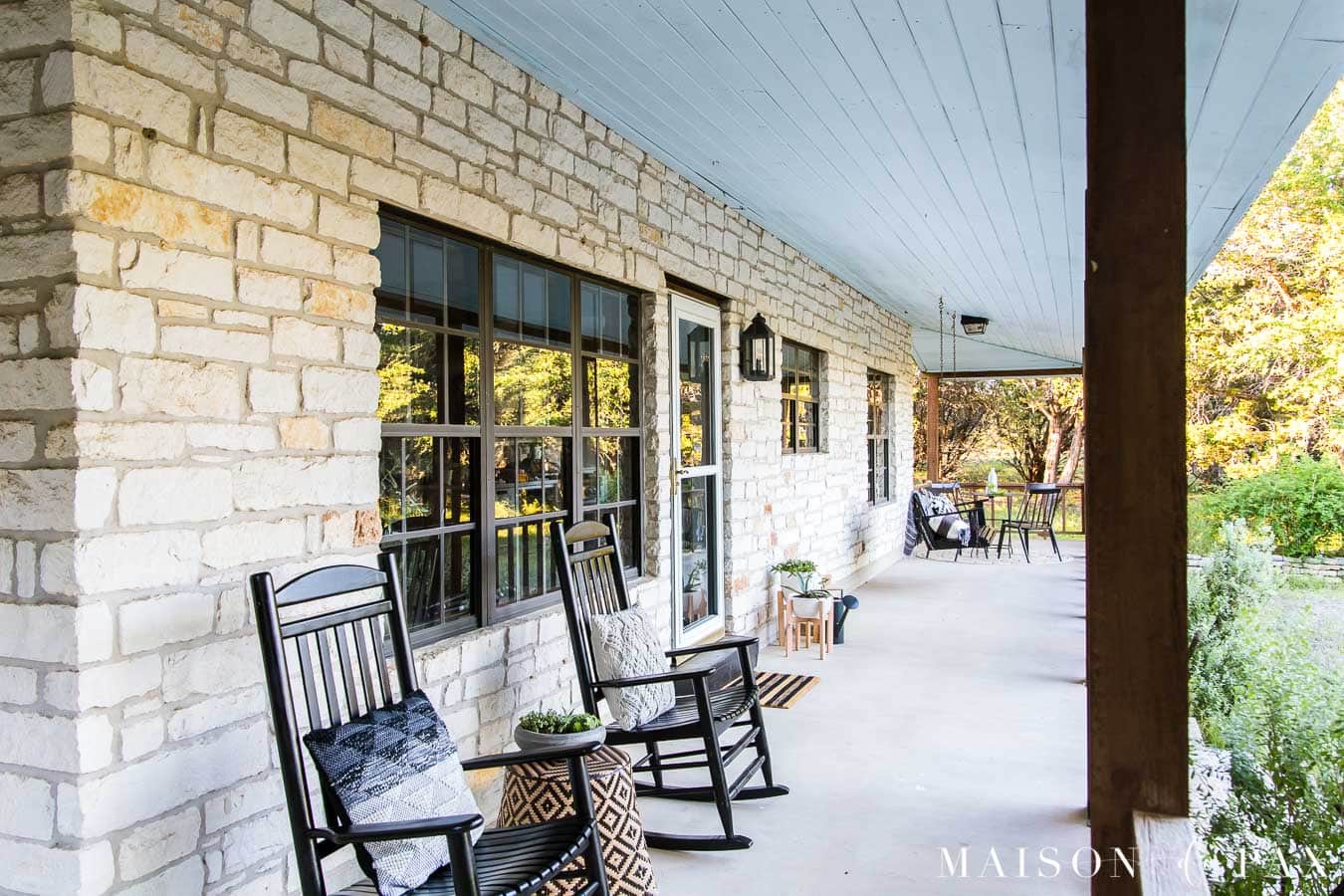 charming farmhouse porch with black rocking chairs and porch swing | Maison de Pax
