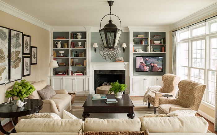 traditional fireplace with built in bookcases holding tv- Maison de Pax