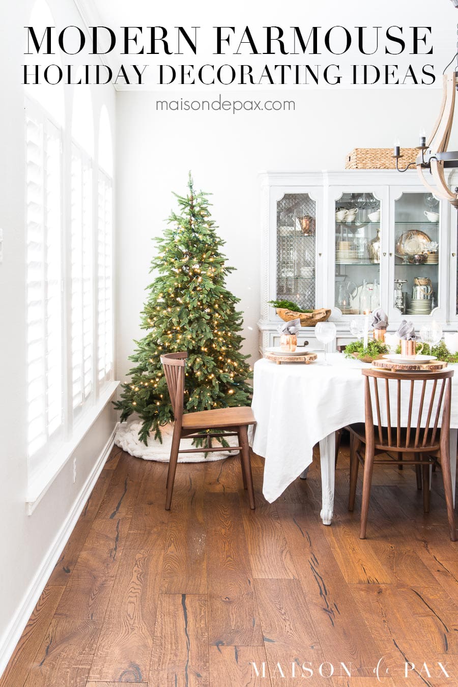 view of wooden staircase and dining room beyond with Christmas tree and text overlay that reads "modern farmhouse holiday entertaining ideas"