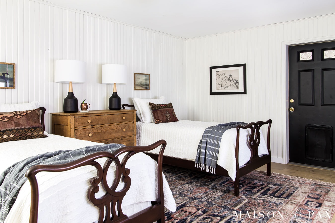 twin bedroom with white planked walls, vintage furniture, and colorful accents | Maison de Pax