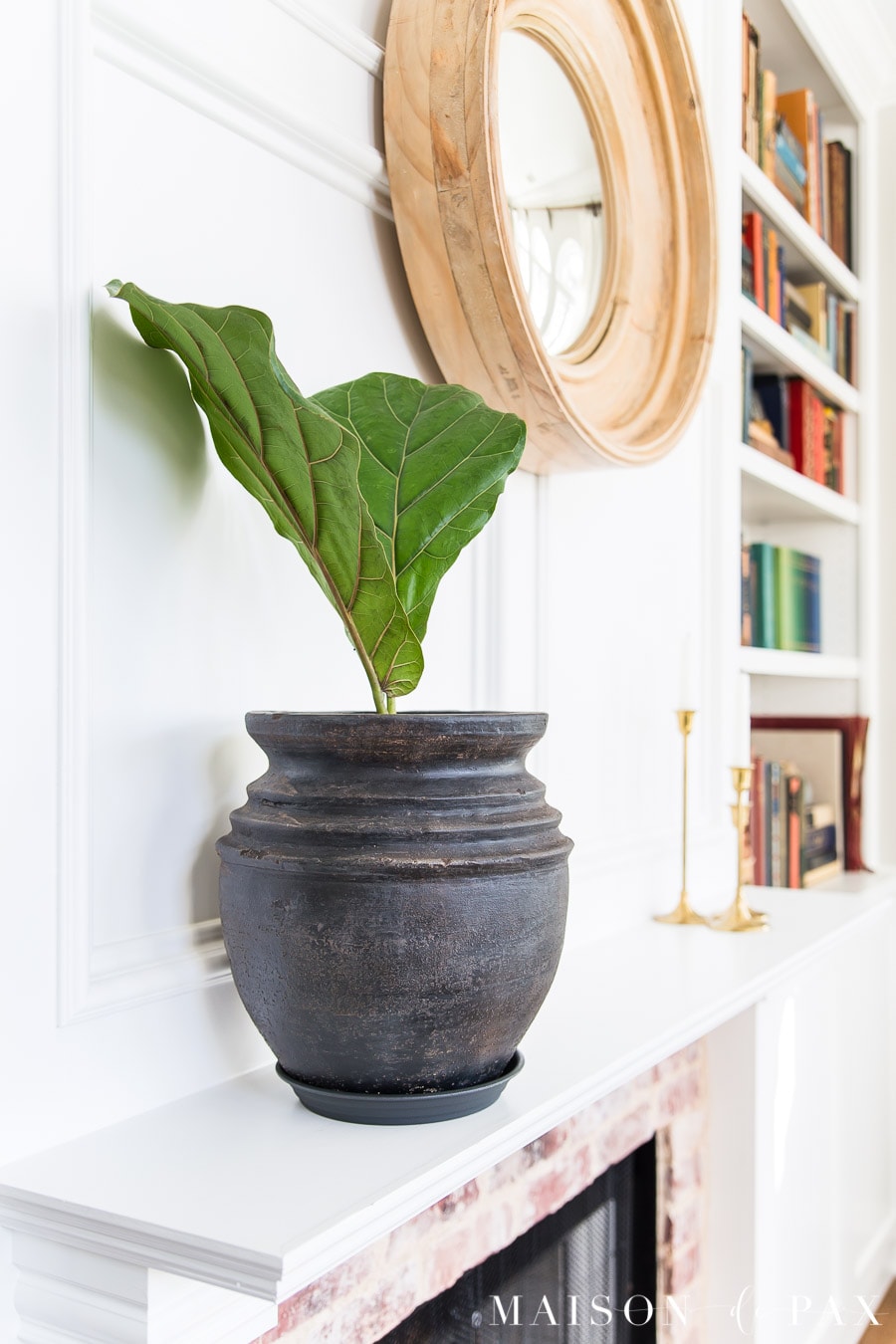 aged black pottery on white fireplace mantel | Maison de Pax