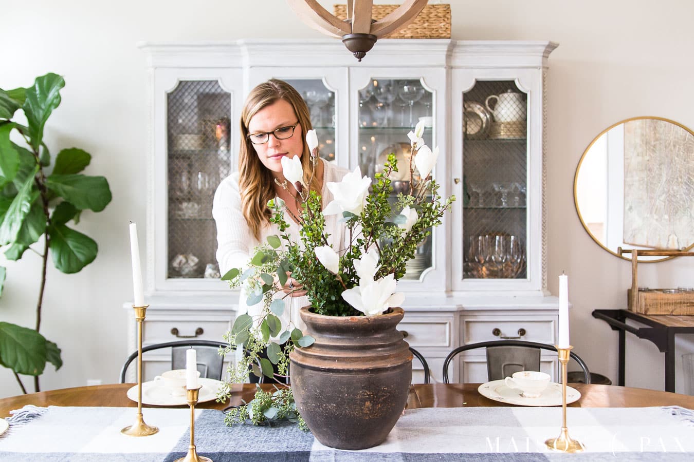 woman arranging holiday centerpiece | Maison de Pax