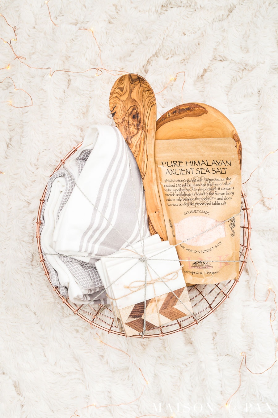 round copper basket with dish towels, coasters, and sea salt