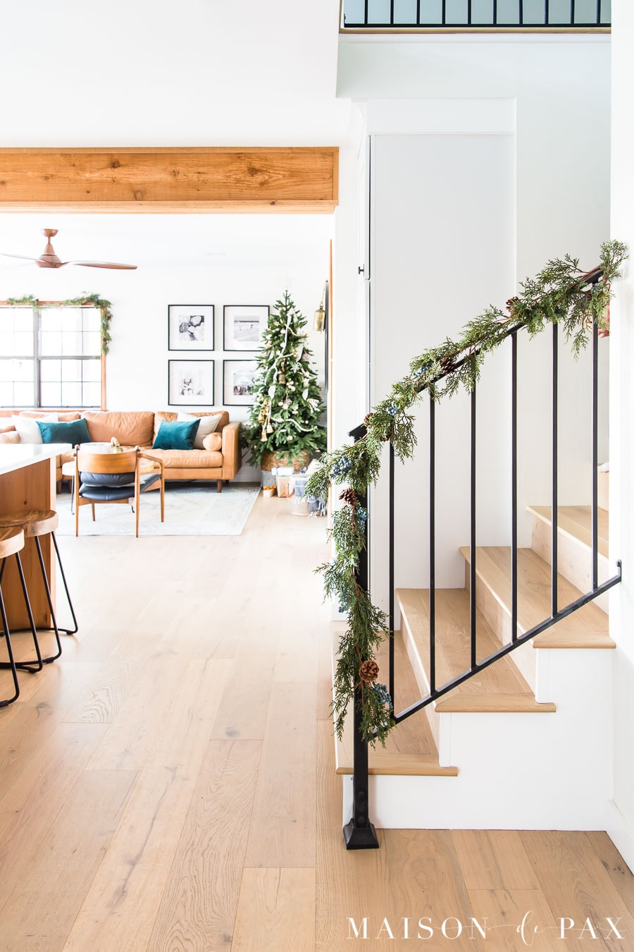 black metal stair railing with garland in fresh modern farmhouse | Maison de Pax