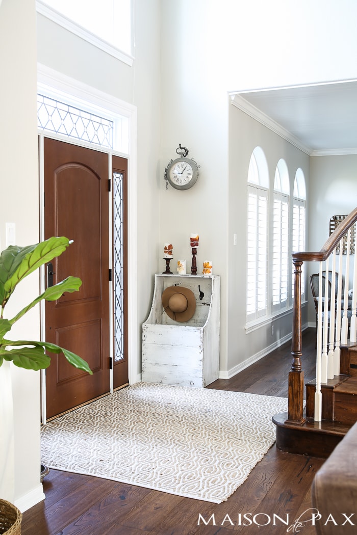 Beautiful light-filled foyer with a touch of fall decor