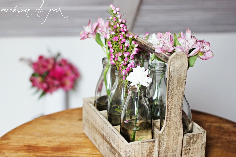 This stunning carrier made from reclaimed wood holds 6 antique milk bottles and makes the perfect rustic yet elegant piece of decor!