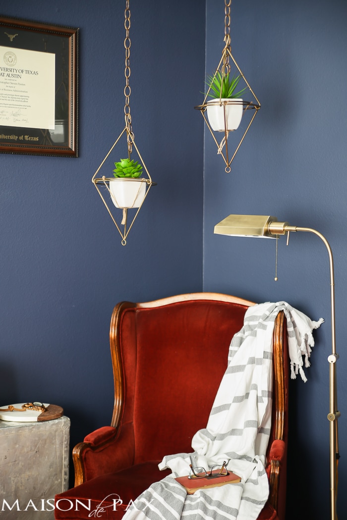 Love this dark, moody, navy office with red and brass accents