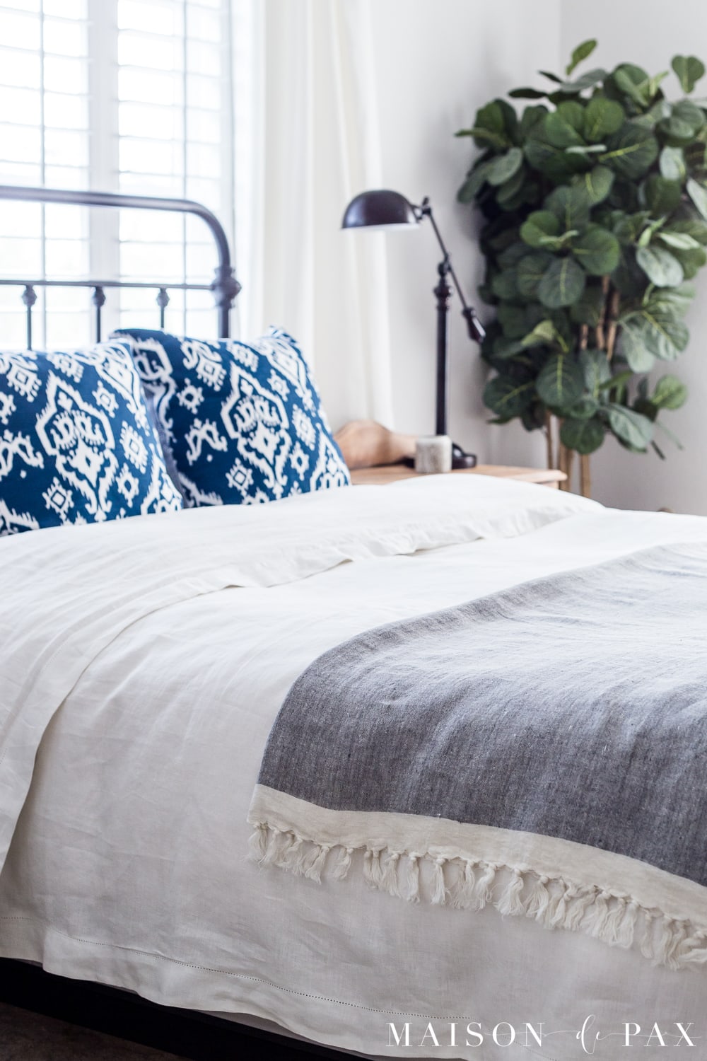 tip #2: use a linen throw... Looking to add a seasonal touch to your bedroom?  Don't miss these incredibly simple master bedroom decorating ideas for spring! #springdecor #springbedroom #nightstand #modernfarmhouse