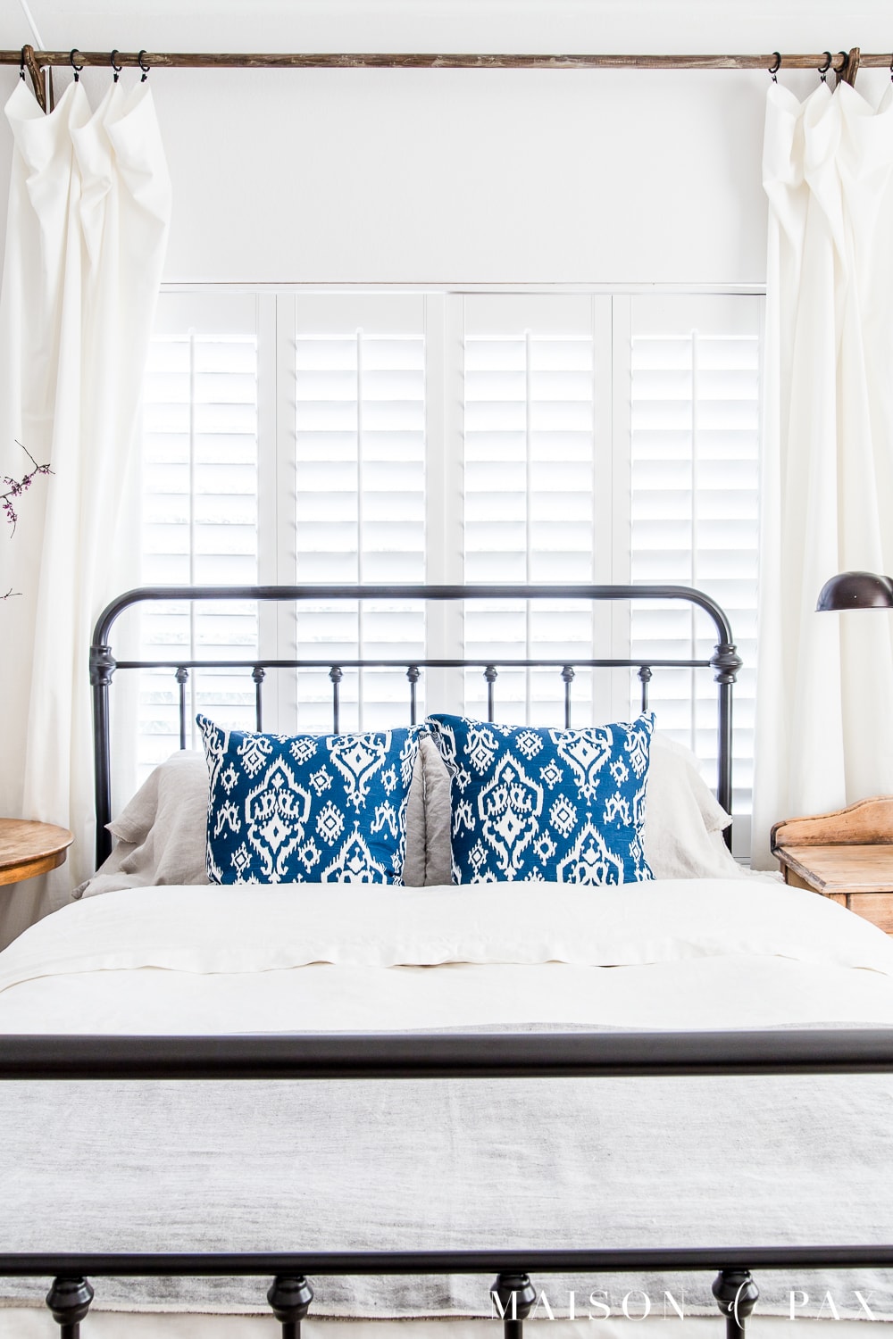 White linen duvet and bold blue pillows... Looking to add a seasonal touch to your bedroom?  Don't miss these incredibly simple master bedroom decorating ideas for spring! #springdecor #springbedroom #nightstand #modernfarmhouse