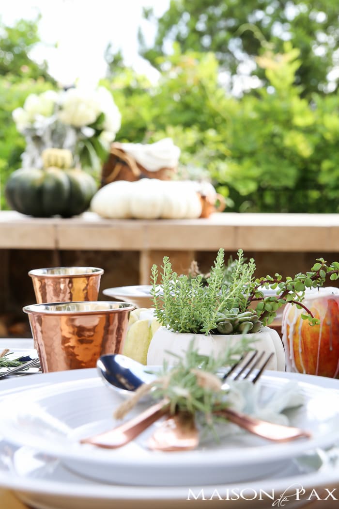 10 tips for a magical outdoor dining table: lanterns, string lights, apple candles, and other cozy outdoor fall decorating ideas!