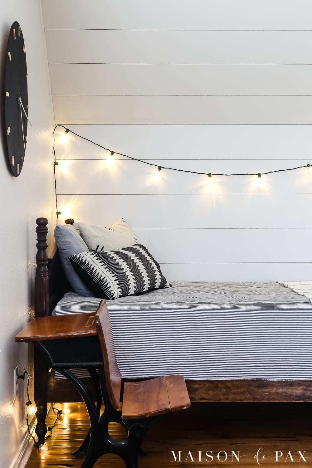Plastic globe lights and wood wall clock for a boy's bed nook!  Learn how to make this DIY black and wood giant wall clock for cheap! #wallart #diywallart #diyclock #wallclock #giantclock #modernfarmhouse #neutraldecor #kidsroom #boyroom #modernfarmhouse #blackandwhiteinteriors
