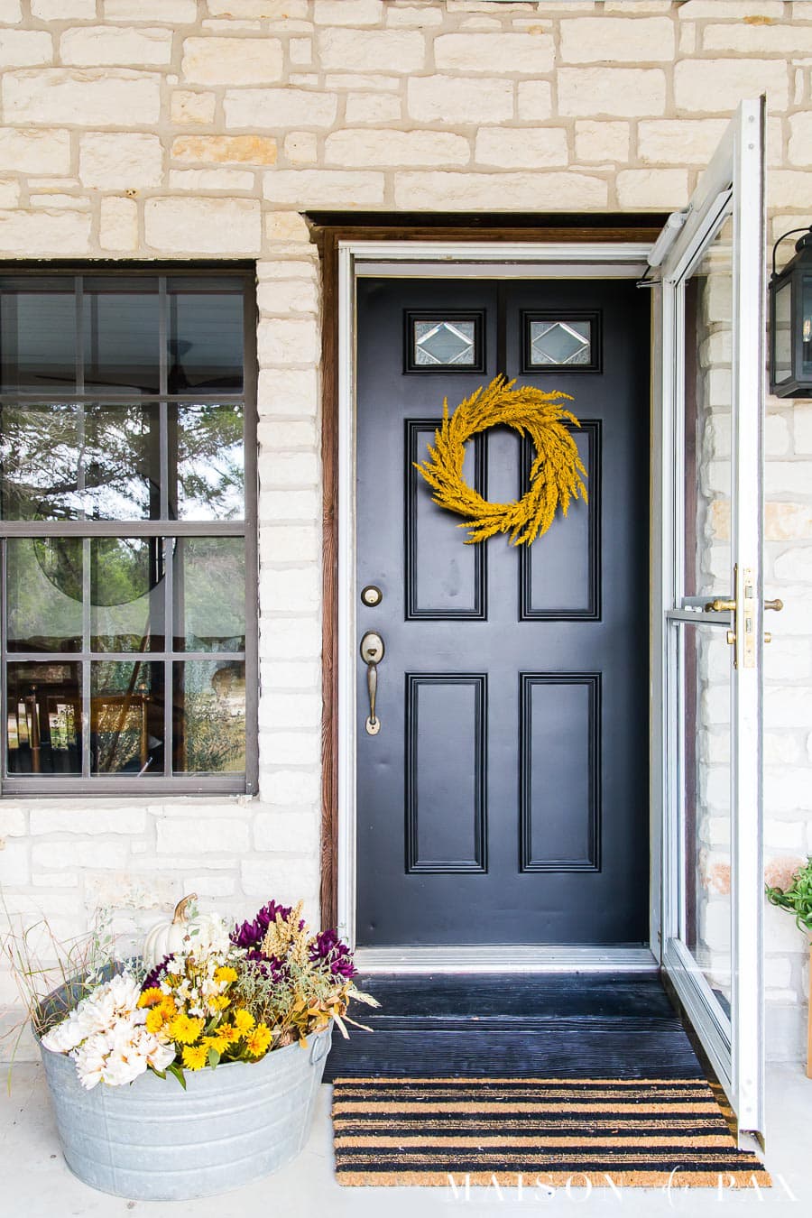 black door with gold wreath and fall decor