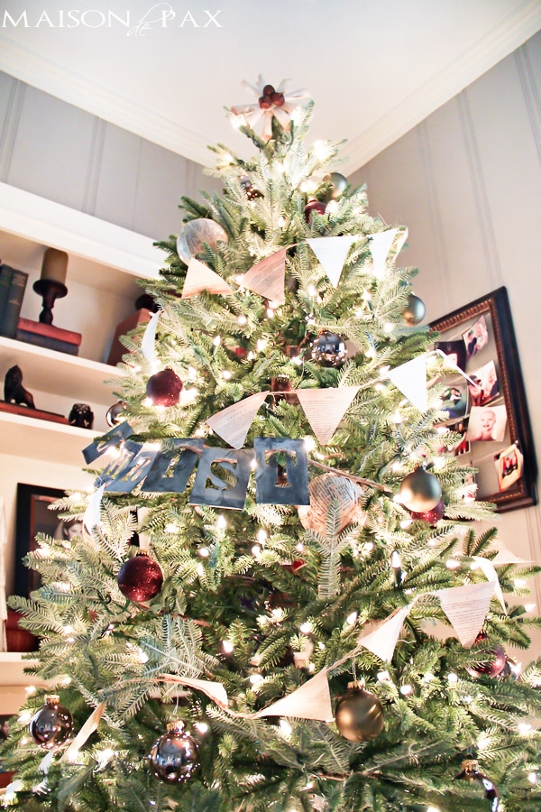Love this simple Christmas tree decorating idea! Book page bunting and ornaments with stenciled words... Simple and beautiful! via aiweb9ygdry.cmersite.com