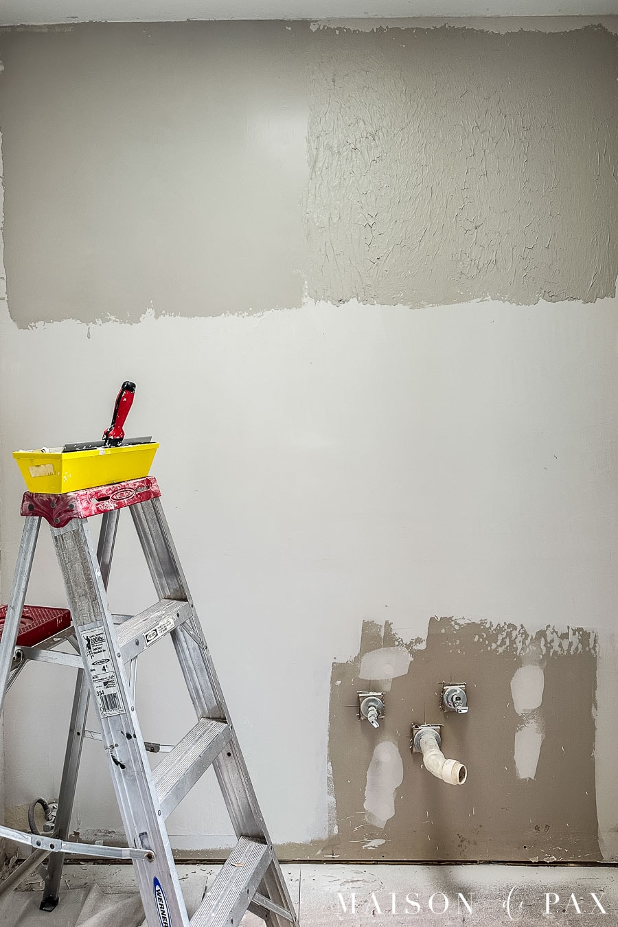 Empty room with drywall skim coating in progress