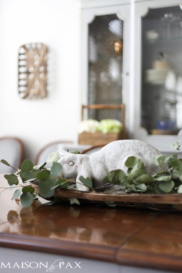 What a cute, simple idea for Easter decor! Use a garden statue bunny in a basket with dried greens as a centerpiece for your table | aiweb9ygdry.cmersite.com