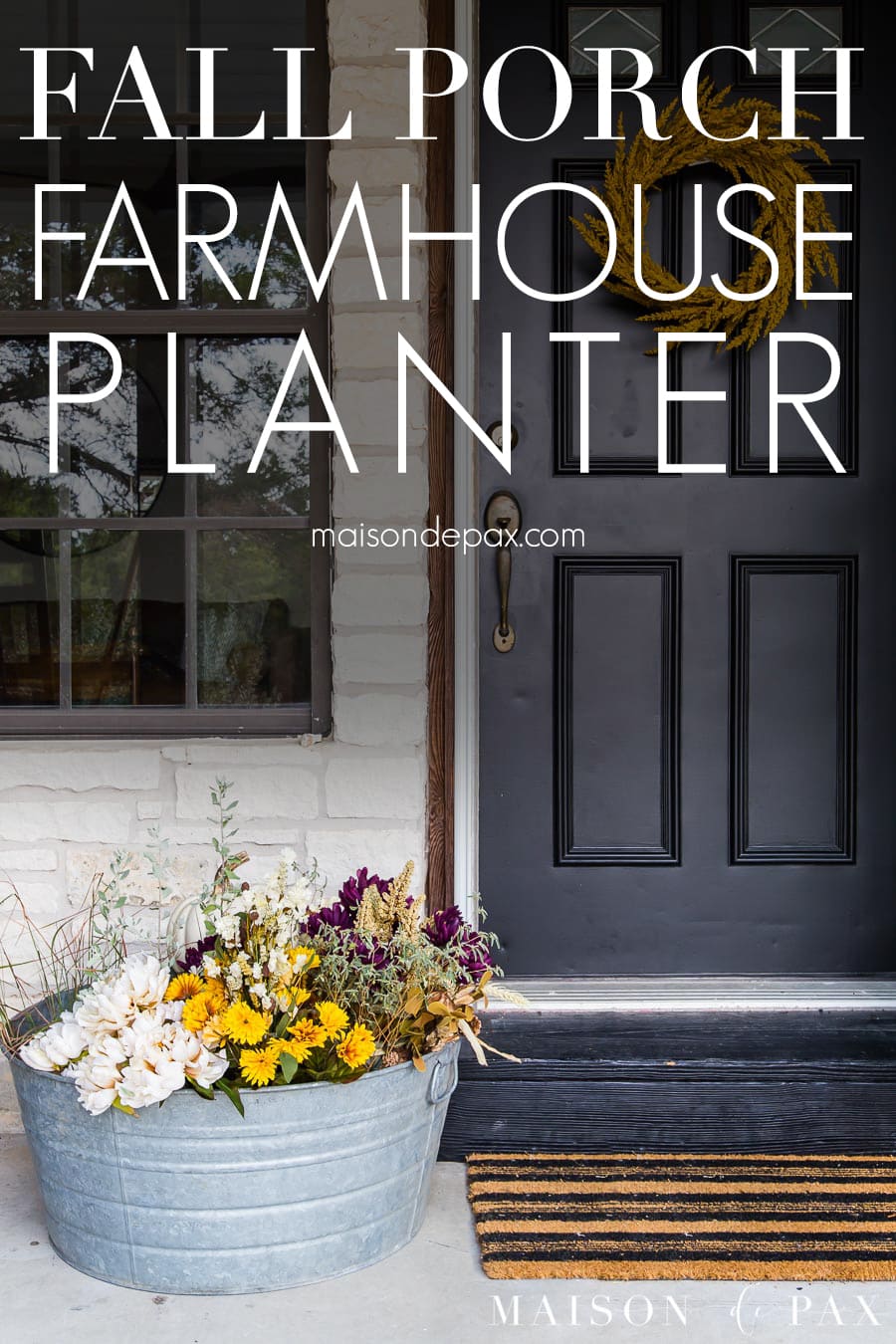 black front door with colorful planter beside | Maison de Pax