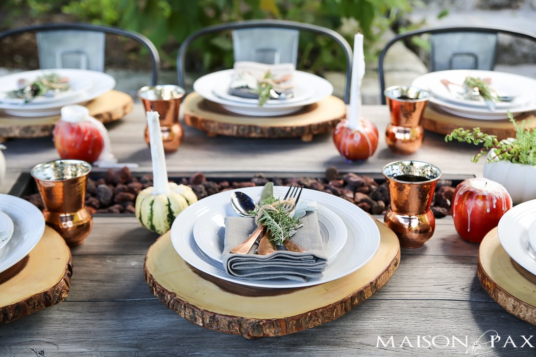 10 tips for a magical outdoor dining table: lanterns, string lights, apple candles, and other cozy outdoor fall decorating ideas!
