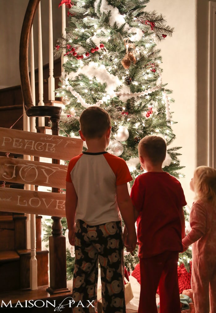 Kids in front of lit Christmas tree- Maison de Pax
