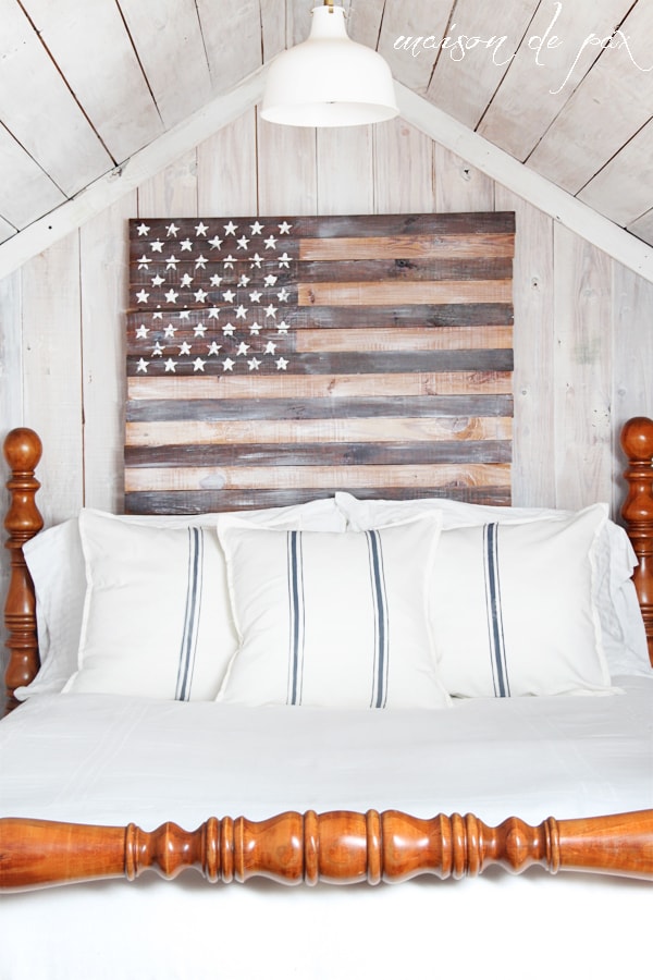 Close up of white bedding and planked American Flag- Maison de Pax