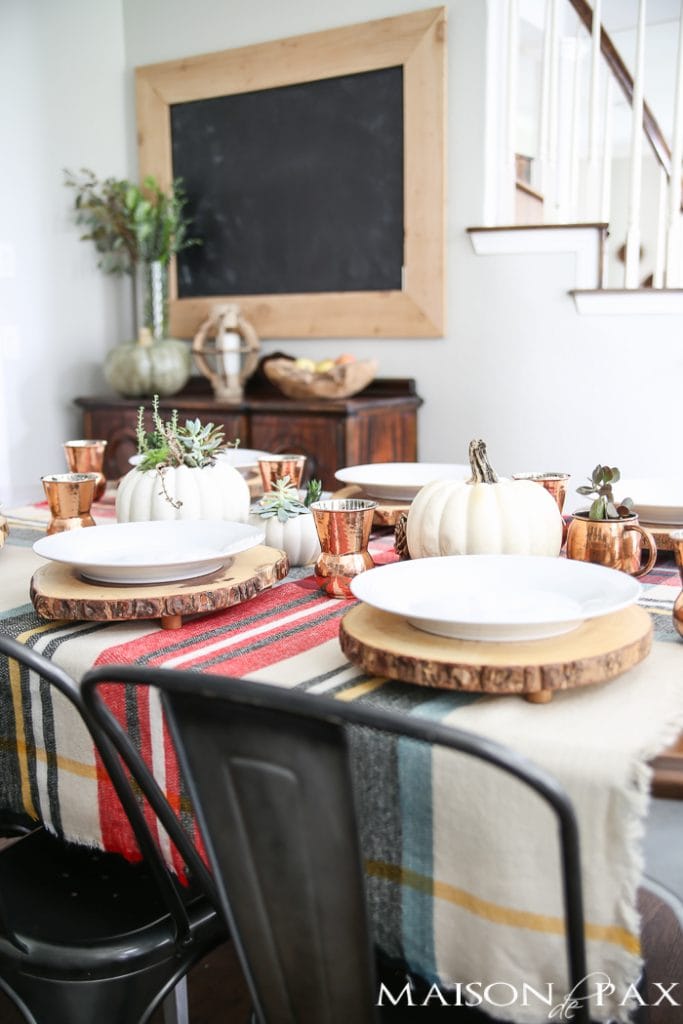 Be inspired to create a gorgeous, rustic Thanksgiving tablescape with these Thanksgiving decorating ideas! This table incorporates plaid, copper, and wood to create a beautiful yet relaxed look.