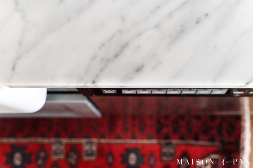 Wear along edge of marble countertops: Should I use marble in the kitchen?  It's one of the most common questions for today's kitchen design!  Read all about the pros and cons of marble countertops as well as what it is like living with honed marble countertops in a household with kids. #carraramarble #marblebacksplash #marblecountertops #marblecounters #marblekitchen